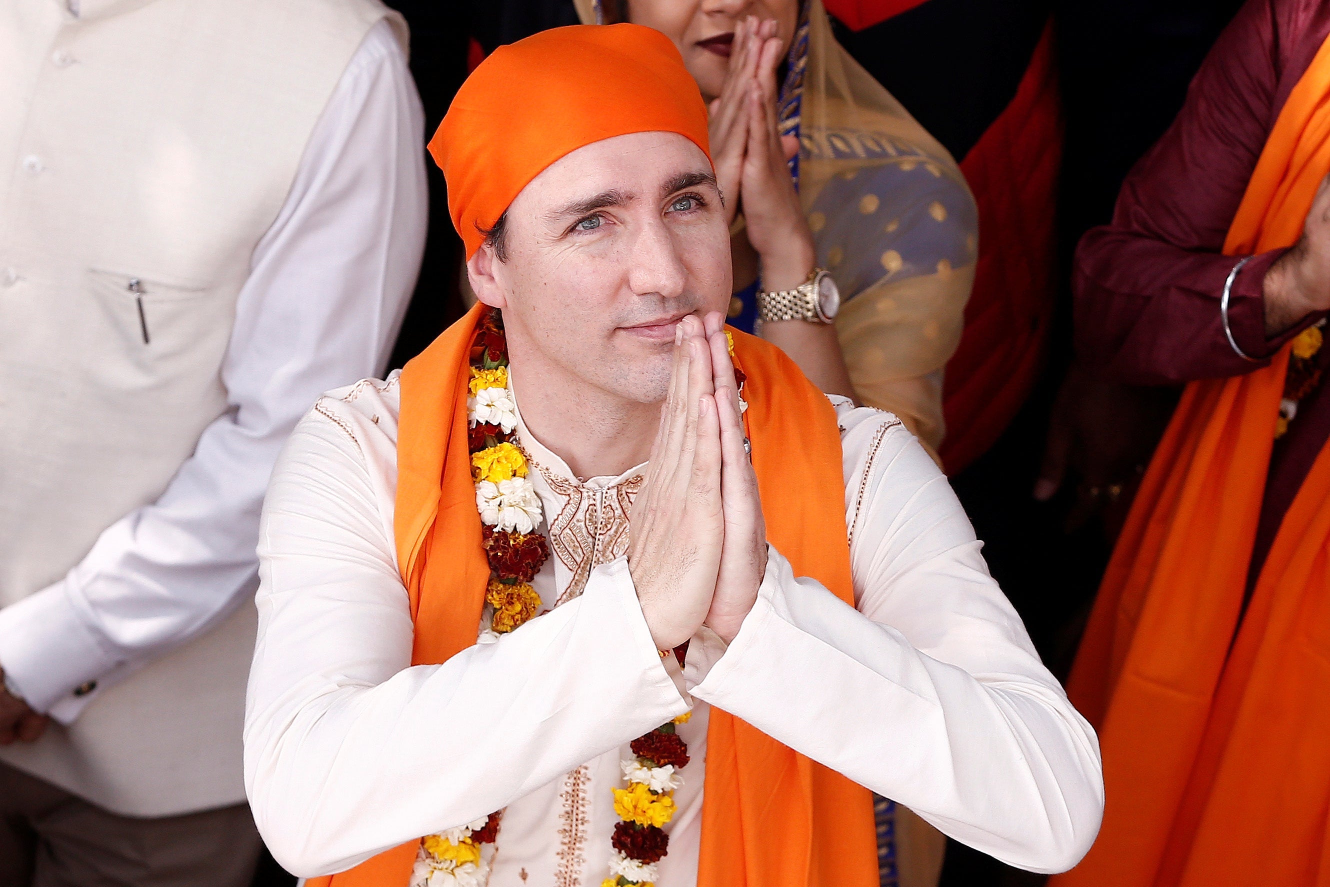 Justin Trudeau folds his hands in prayer while visiting a temple.