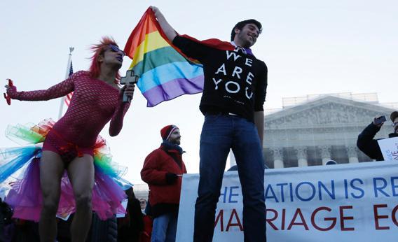 A protester dressed as a devil who said his name is "Queen" stands with another demonstrator outside of the U.S. Supreme Court in Washington, March 26, 2013.