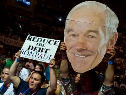 A supporter of Ron Paul waves his portrait during the Sunday rally in Tampa.