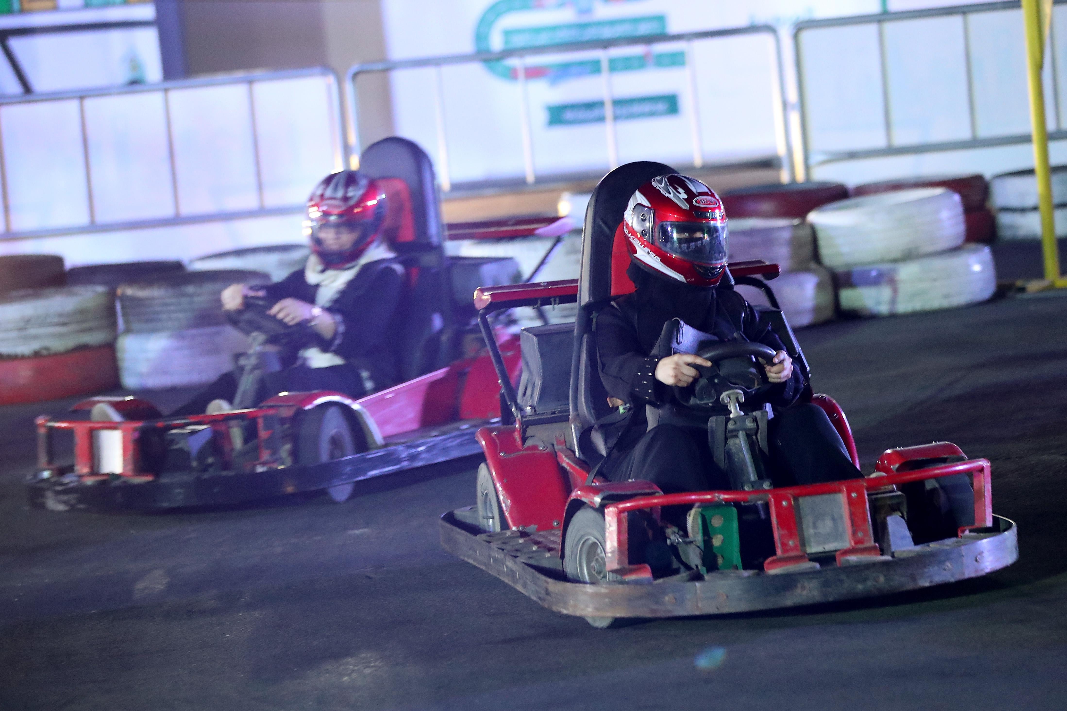 Women try out driving go-karts at an outdoor educational driving event for women on June 21, 2018 in Jeddah, Saudi Arabia. 