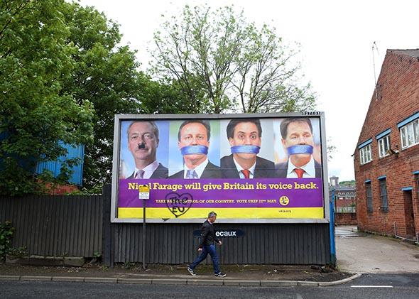 A man walks past a defaced UKIP poster on May 22, 2014 in Sheffield, England. 
