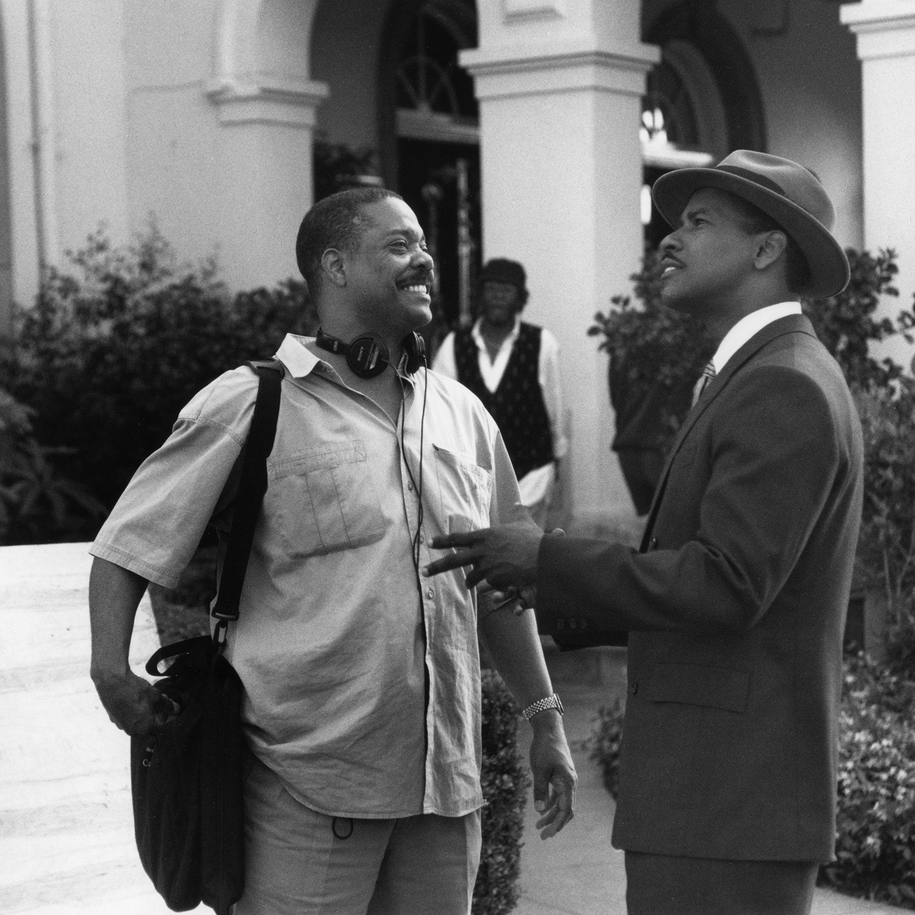 Two men talking on a movie set, one the director, the other an actor in costume.
