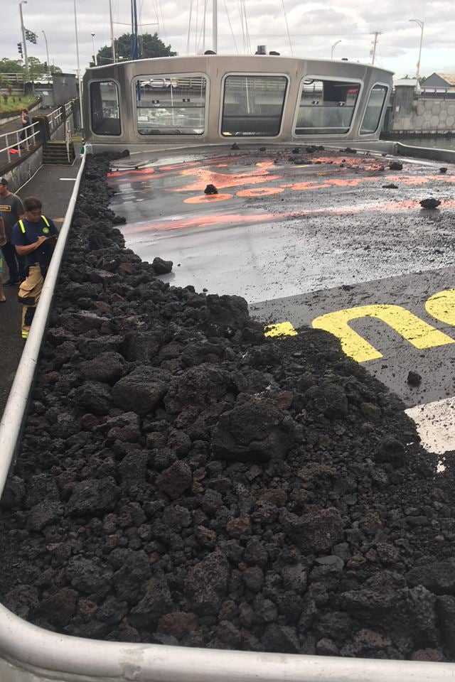 Piles of rock and ash on top of the tour boat