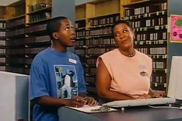 Two women talking in a video store.