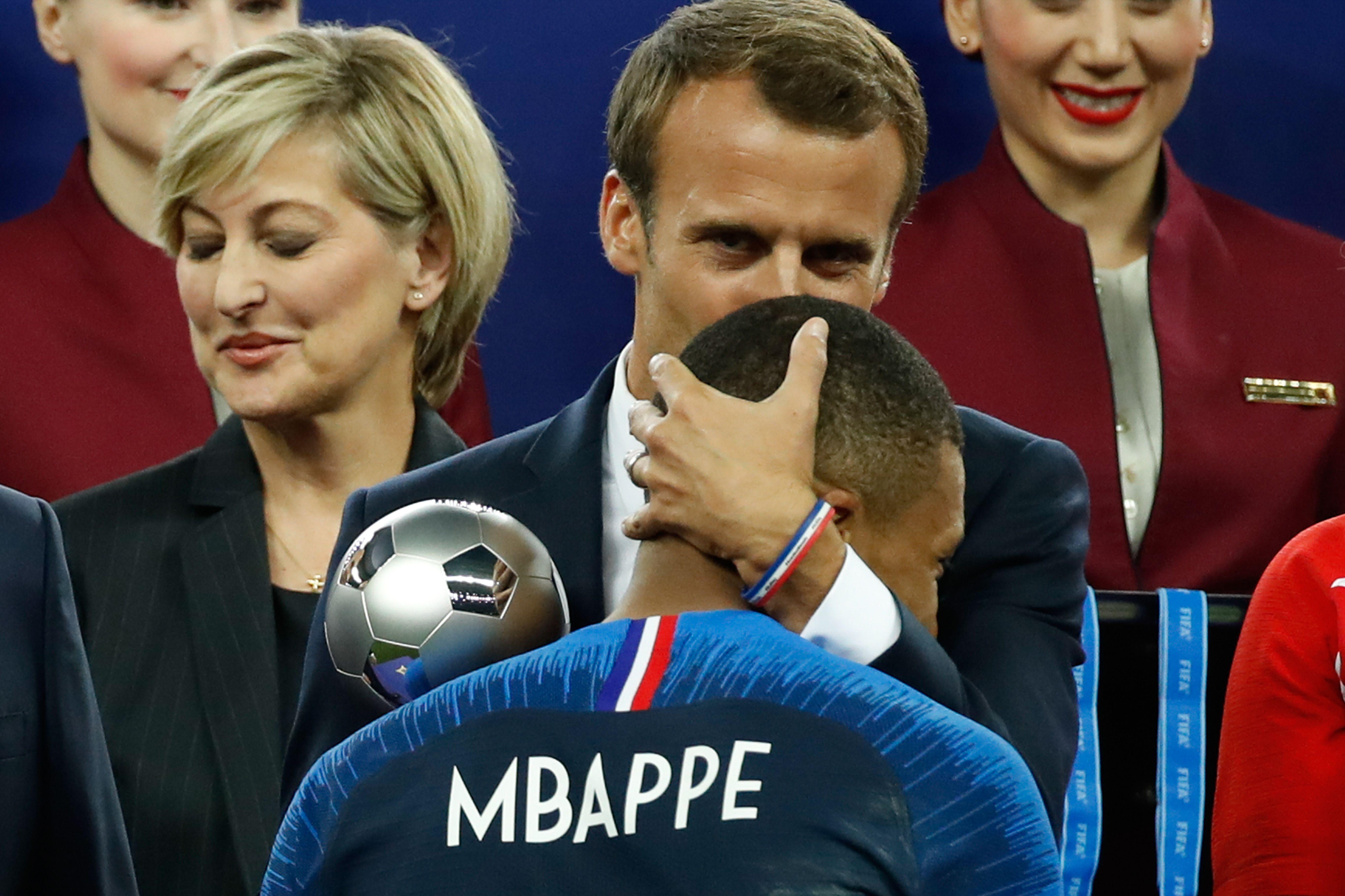 France's forward Kylian Mbappe receives the silver ball for best young player from French President Emmanuel Macron during the medals ceremony after the Russia 2018 World Cup final football match between France and Croatia at the Luzhniki Stadium in Moscow on July 15, 2018. 