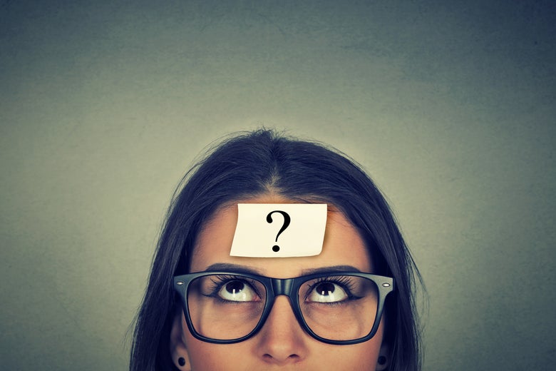 Woman in glasses with a question mark on her forehead.