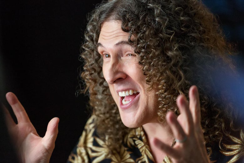 Curly-haired "Weird Al" Yankovic in close-up.