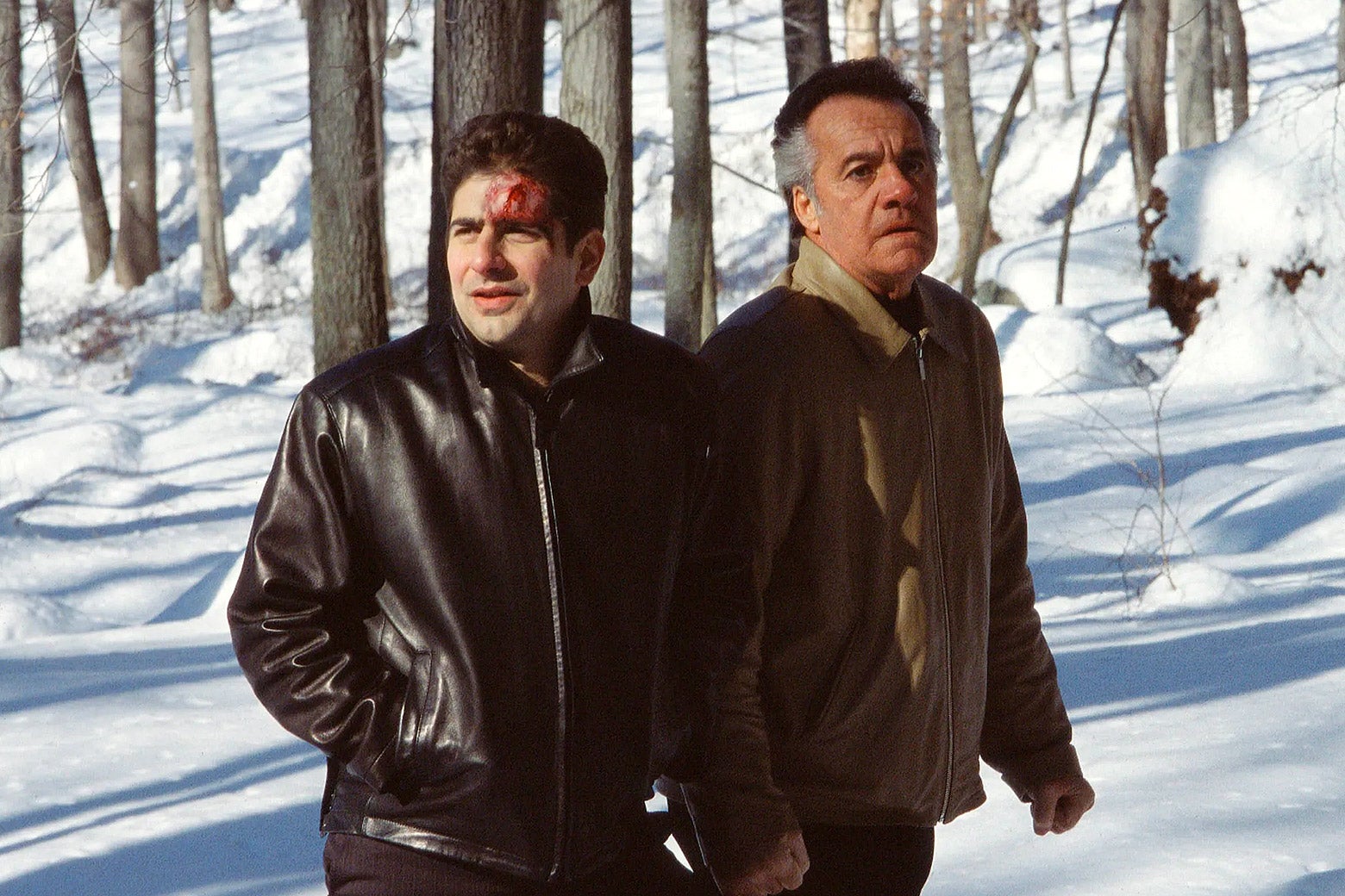 A bloodied Christopher and Paulie walk in the snowy woods.