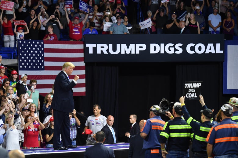 President Trump speaks during a political rally at Charleston Civic Center in Charleston, West Virginia beneath a sign that reads "Trump digs coal." 