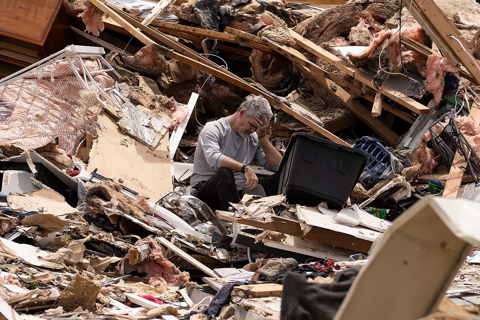 a man in his house during the aftermath of a tornado