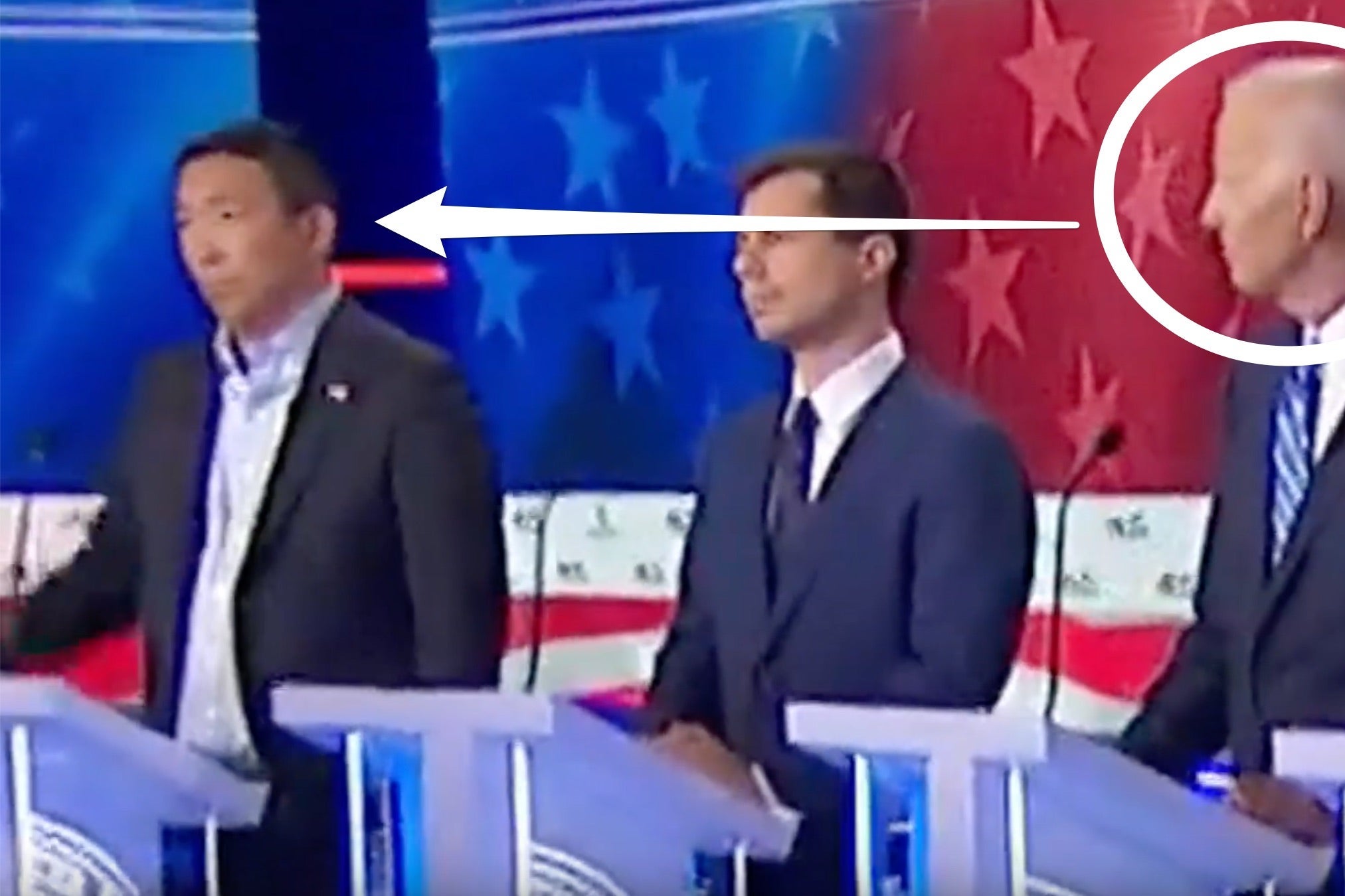 A still of July's Democratic debate shows Biden looking toward Yang to his right