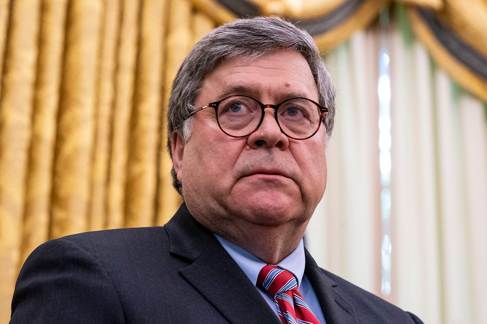 Barr stands in the Oval Office