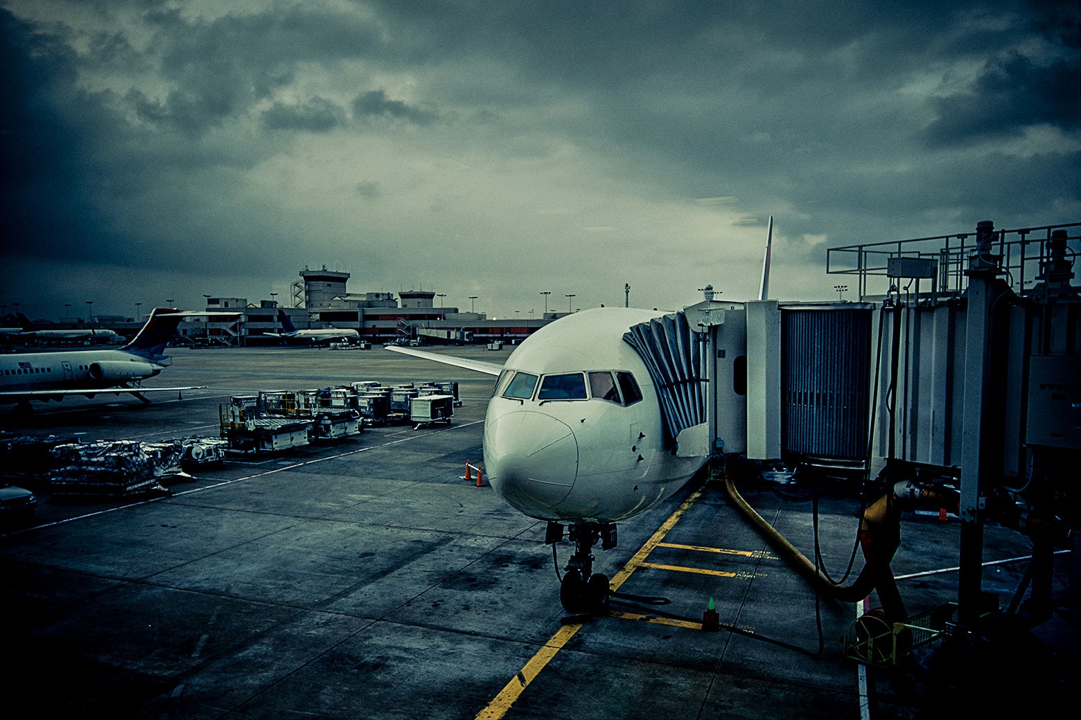 A plane awaits boarding at an airport gate. 