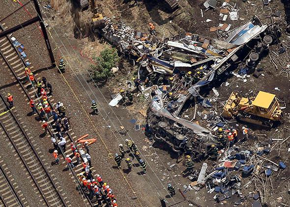 Investigators and first responders work near the wreckage of an Amtrak passenger train carrying more than 200 passengers from Washington, DC to New York that derailed.