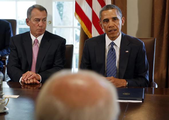 Speaker of the House John Boehner (L) listens to U.S. President Barack Obama at a meeting with bipartisan Congressional leaders in the Cabinet Room at the White House in Washington to discuss a military response to Syria, September 3, 2013.  