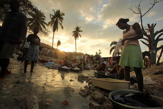 Haitians wash clothes in a stream January 8, 2011 in Port-au-Prince, Haiti.