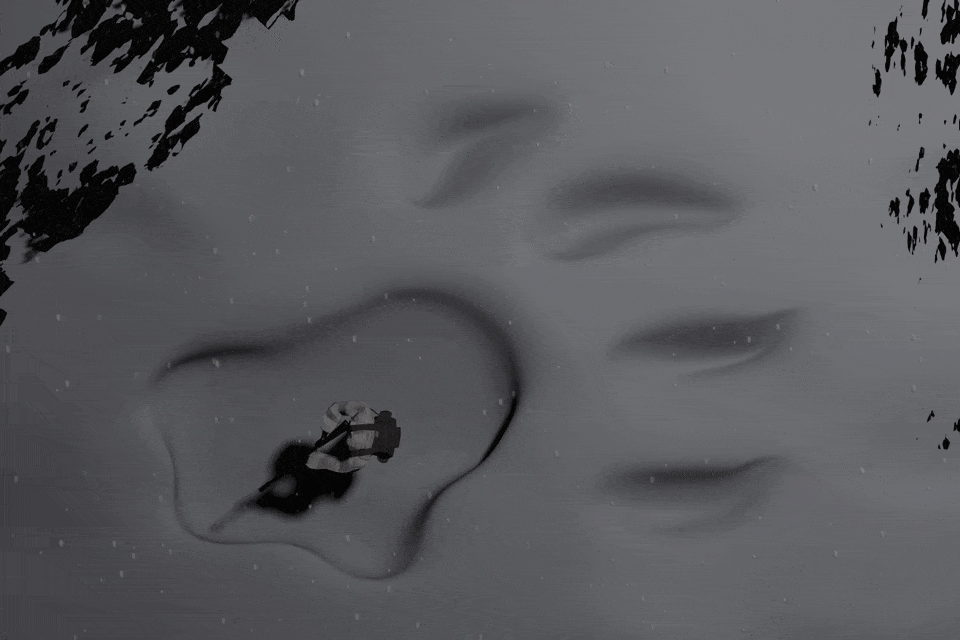 A hunter hides out in the snow inside a giant lion paw print.