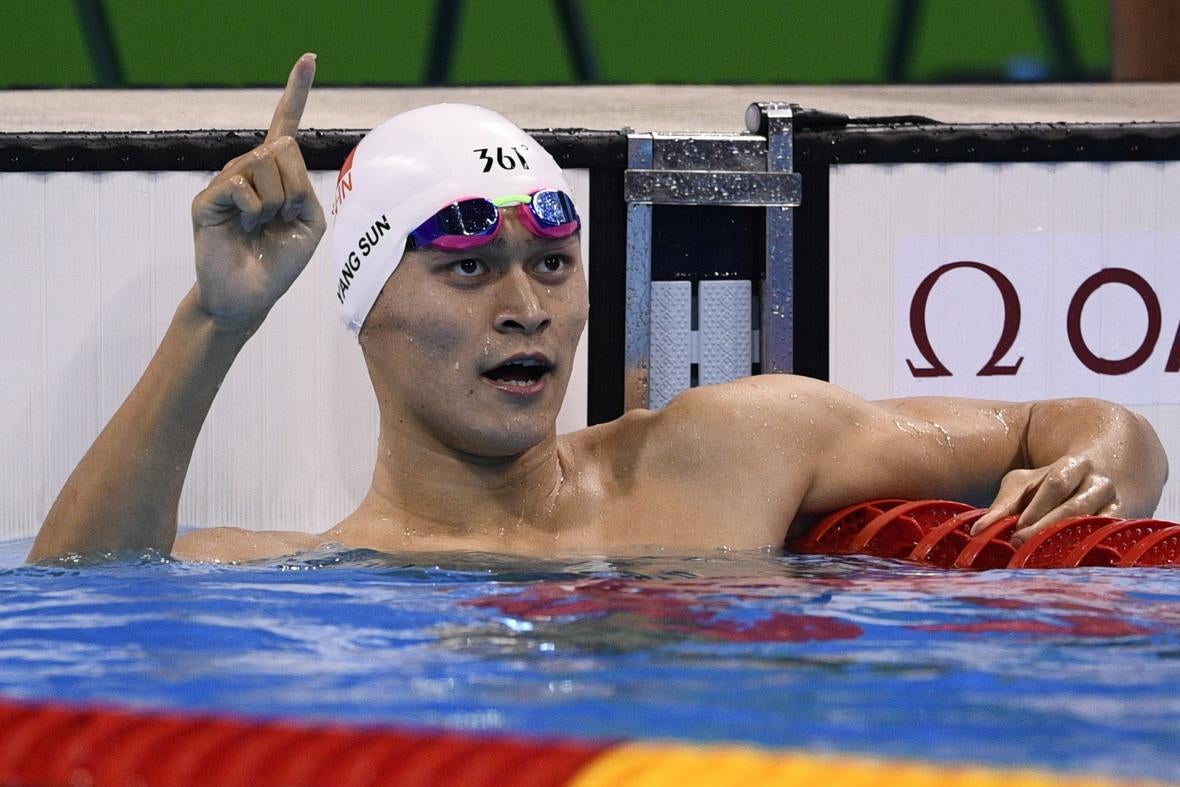Sun Yang resting in the pool and pointing up in the air