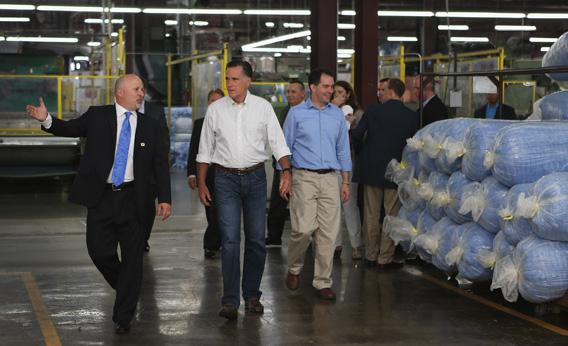 Mitt Romney and Wisconsin Governor Scott Walker walk with Dan Sinykin, president of Monterey Mills, as he gives them a tour of the factory on June 18, 2012 in Janesville, Wisconsin.