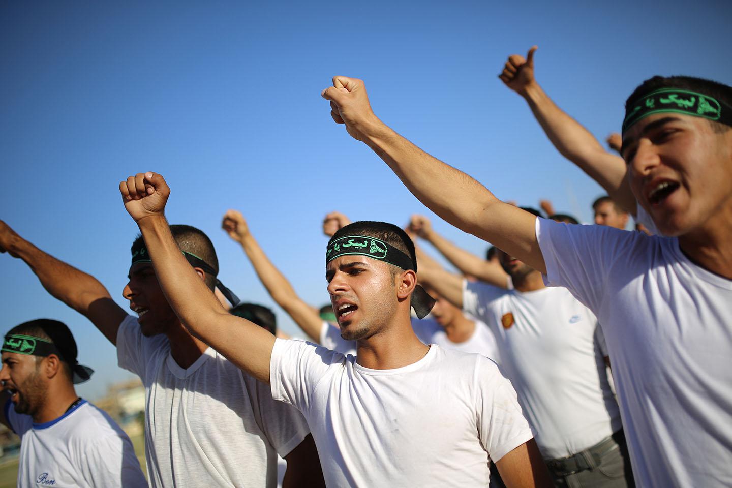 Shiite volunteers, who have joined the Iraqi army to fight against ISIS forces, participate in military-style training in Najaf, June 23, 2014. 