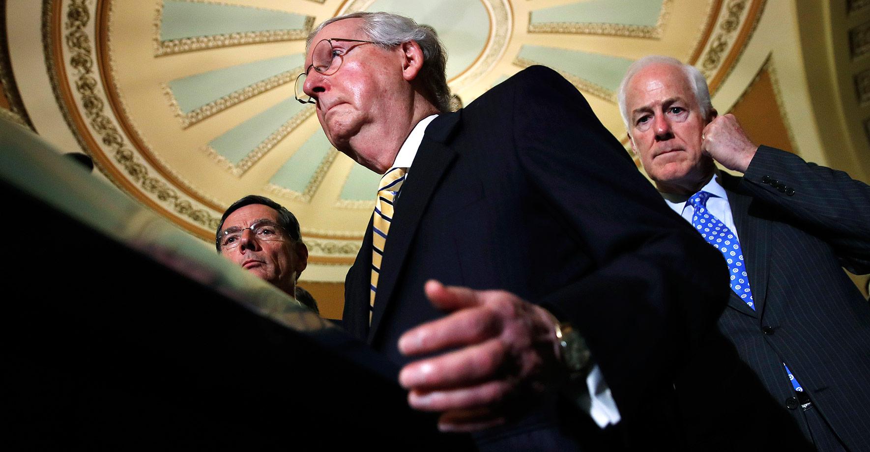 Sen. Mitch McConnell, flanked by Majority Whip Sen. John Cornyn (right) and Sen. John Barrasso, after the Tuesday vote to open debate on Obamacare repeal.