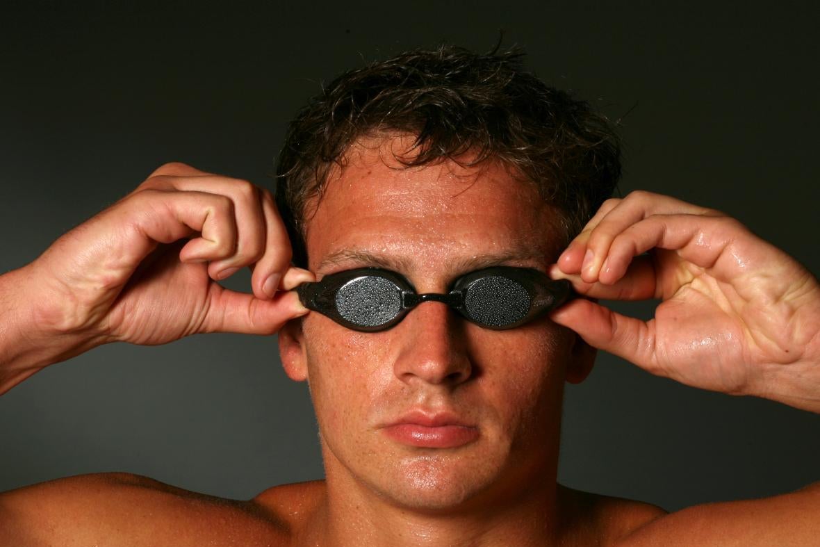 Lochte posing grim-faced with his goggles on, his hands on the corners of the goggles' eyes