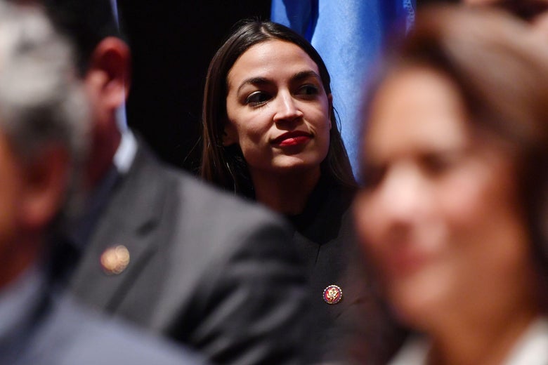 Alexandria Ocasio-Cortez with other members of Congress visible in the foreground.