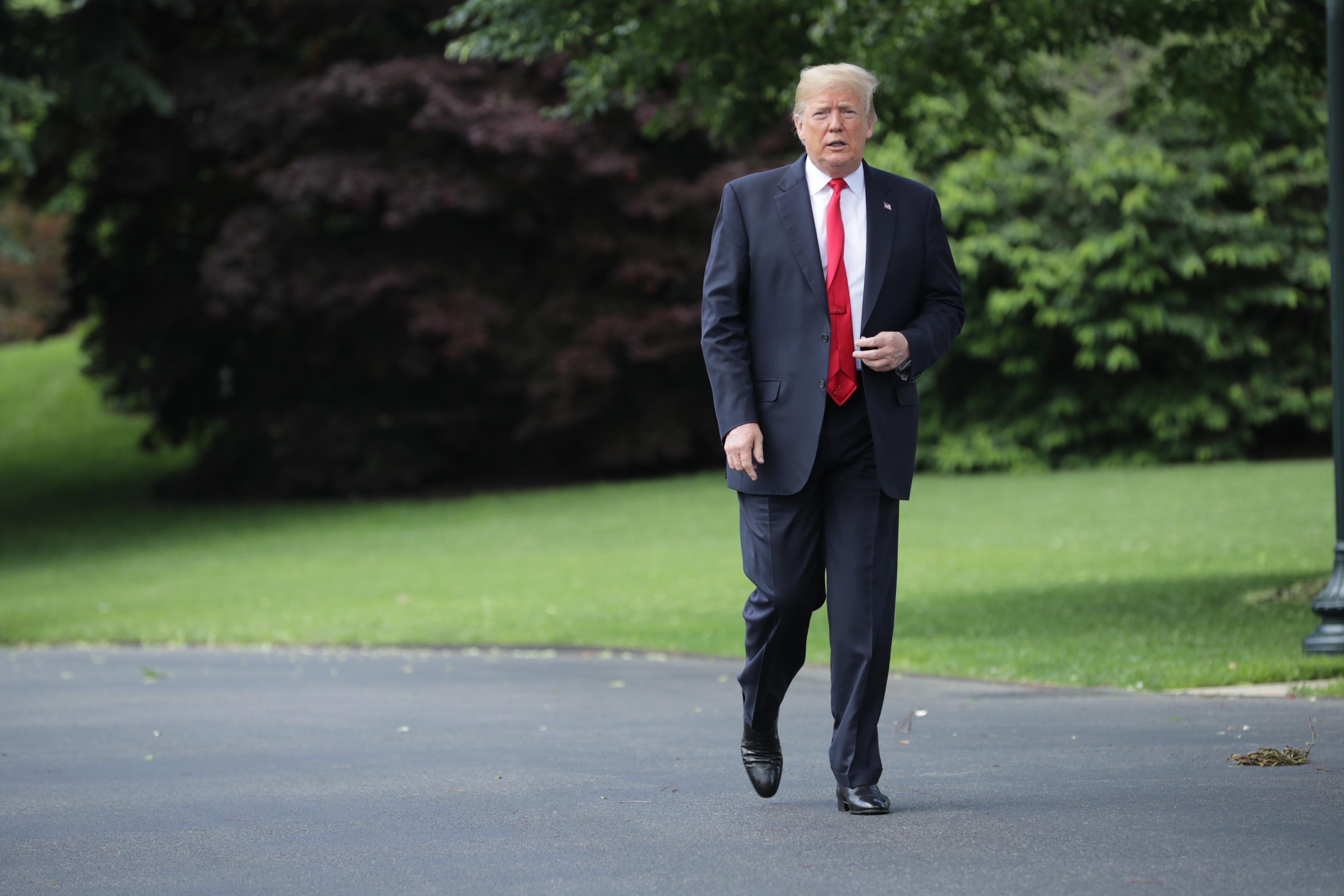 WASHINGTON, DC - MAY 23: U.S. President Donald Trump walks across the South Lawn while departing the White House May 23, 2018 in Washington, DC. Trump is traveling to New York where he will tour the Morrelly Homeland Security Center and then attend a roundtable discussion and dinner with supporters before returning to Washington. (Photo by Chip Somodevilla/Getty Images)