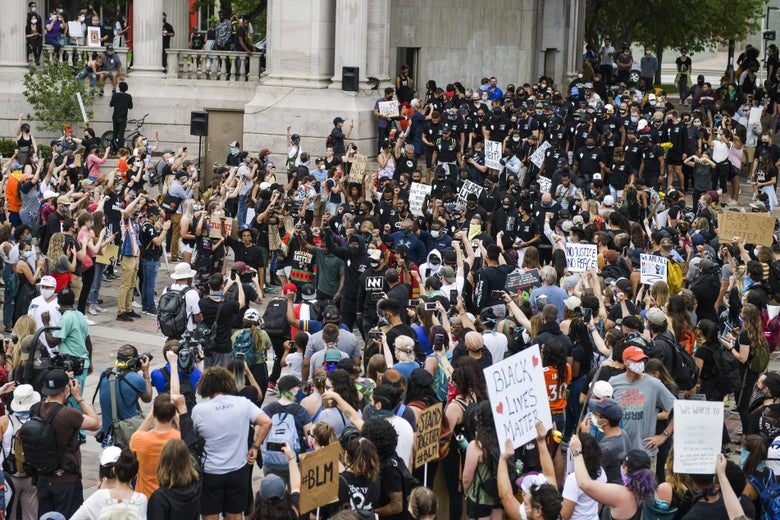 Denver Broncos players lead a crowd of thousands on a march at a protest for the death of George Floyd on June 6, 2020 in Denver, Colorado.