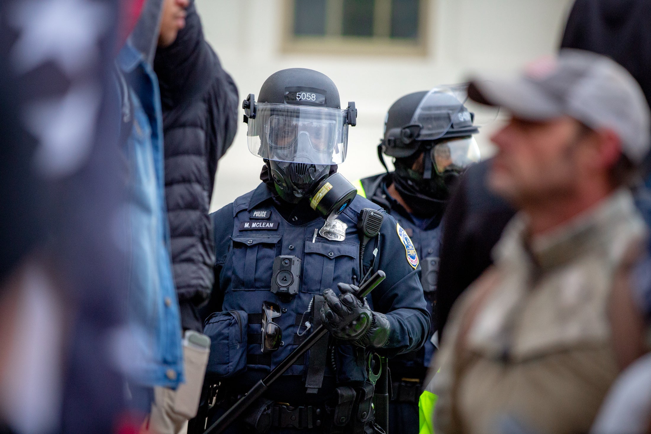 Police with batons outside the Capitol.