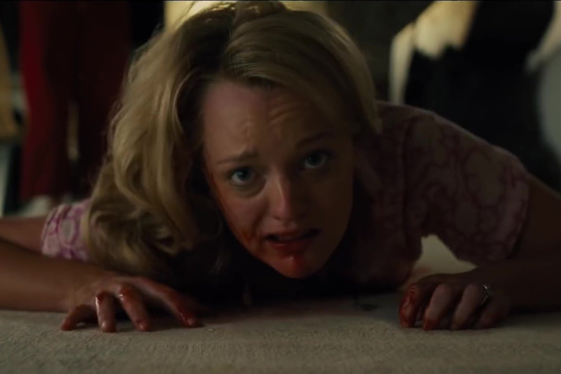 Elisabeth Moss, covered in blood, crawls across a white carpeted floor.