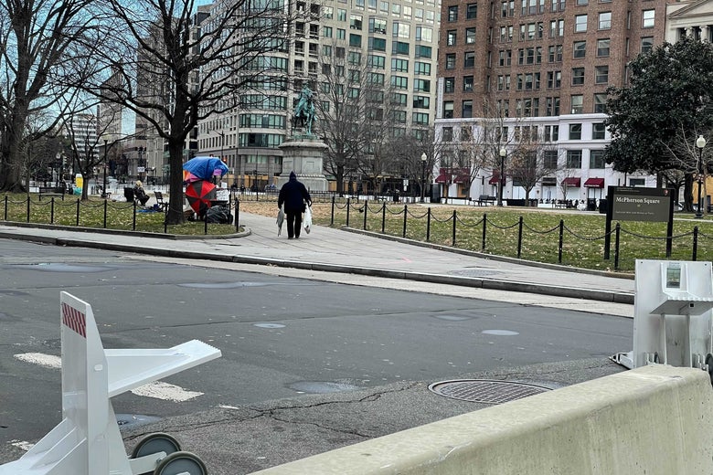 A Trump supporter walking away in the distance.