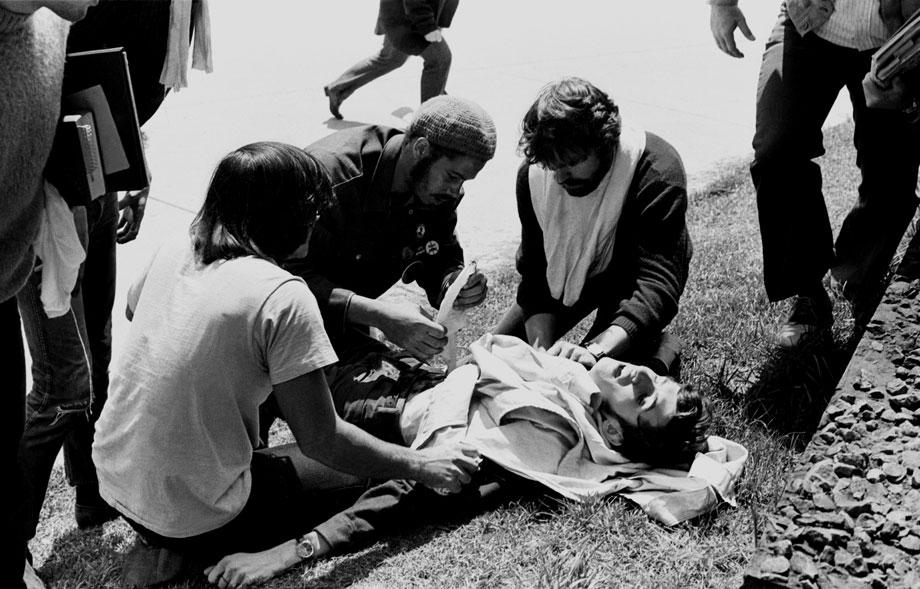 Wounded Kent State student John Cleary is attended to by other students, who helped save his life, May 4, 1970.
