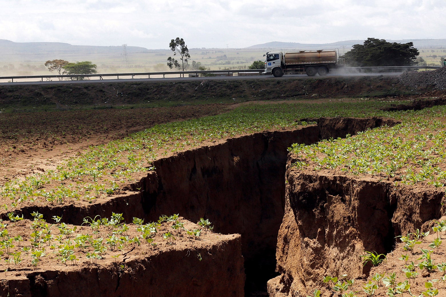 A tanker drives near a chasm suspected to have been caused by a heavy downpour along an underground fault line near the Rift Valley town of Mai-Mahiu, Kenya on 28, 2018.