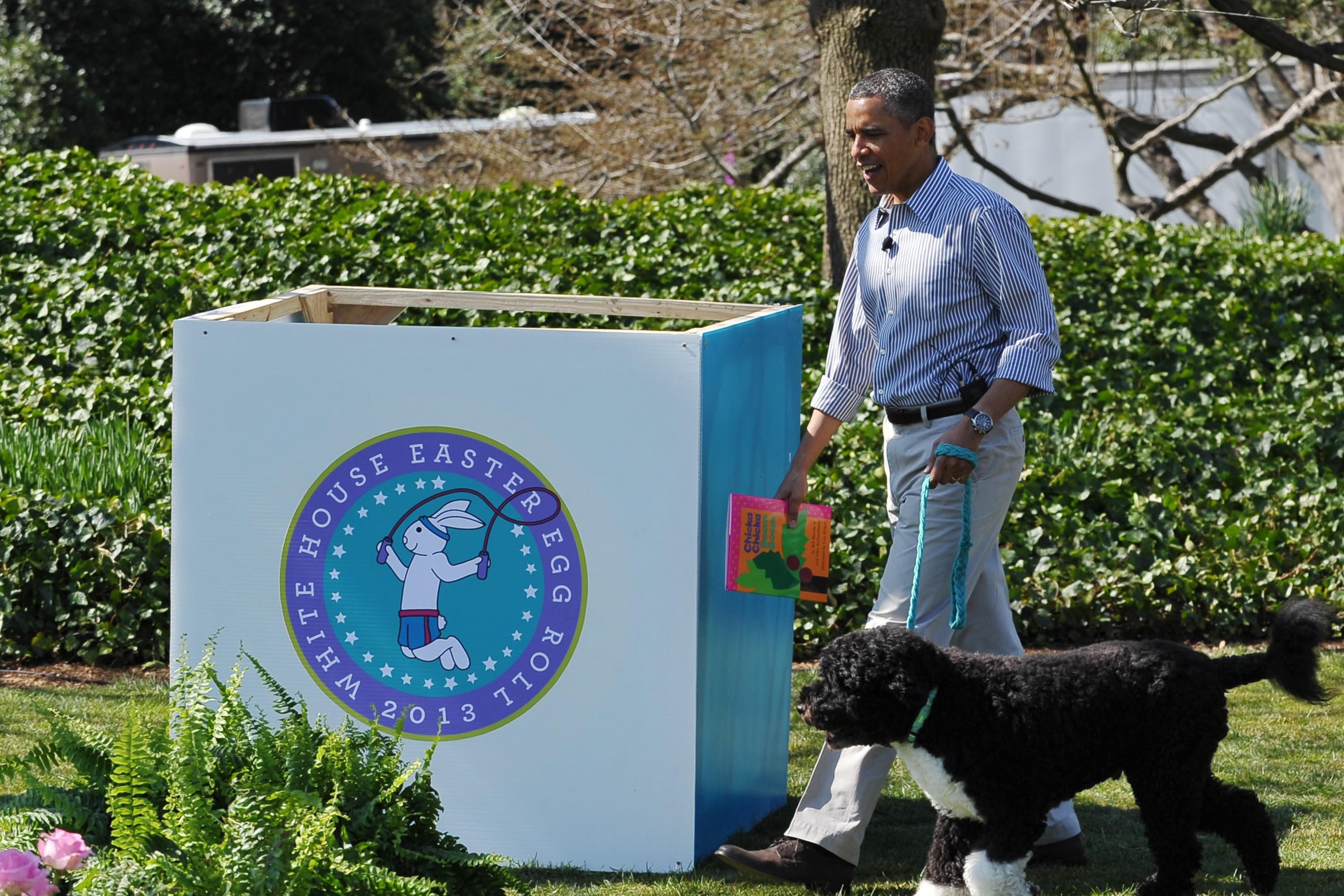 Then-President Barack Obama walks with Bo, the family dog, as he arrives to read a story to children attending the annual Easter Egg Roll on April 1, 2013 on the South Lawn of the White House in Washington, D.C.