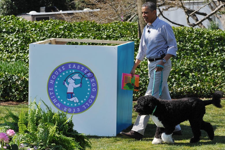 Then-President Barack Obama walks with Bo, the family dog, as he arrives to read a story to children attending the annual Easter Egg Roll on April 1, 2013 on the South Lawn of the White House in Washington, D.C.