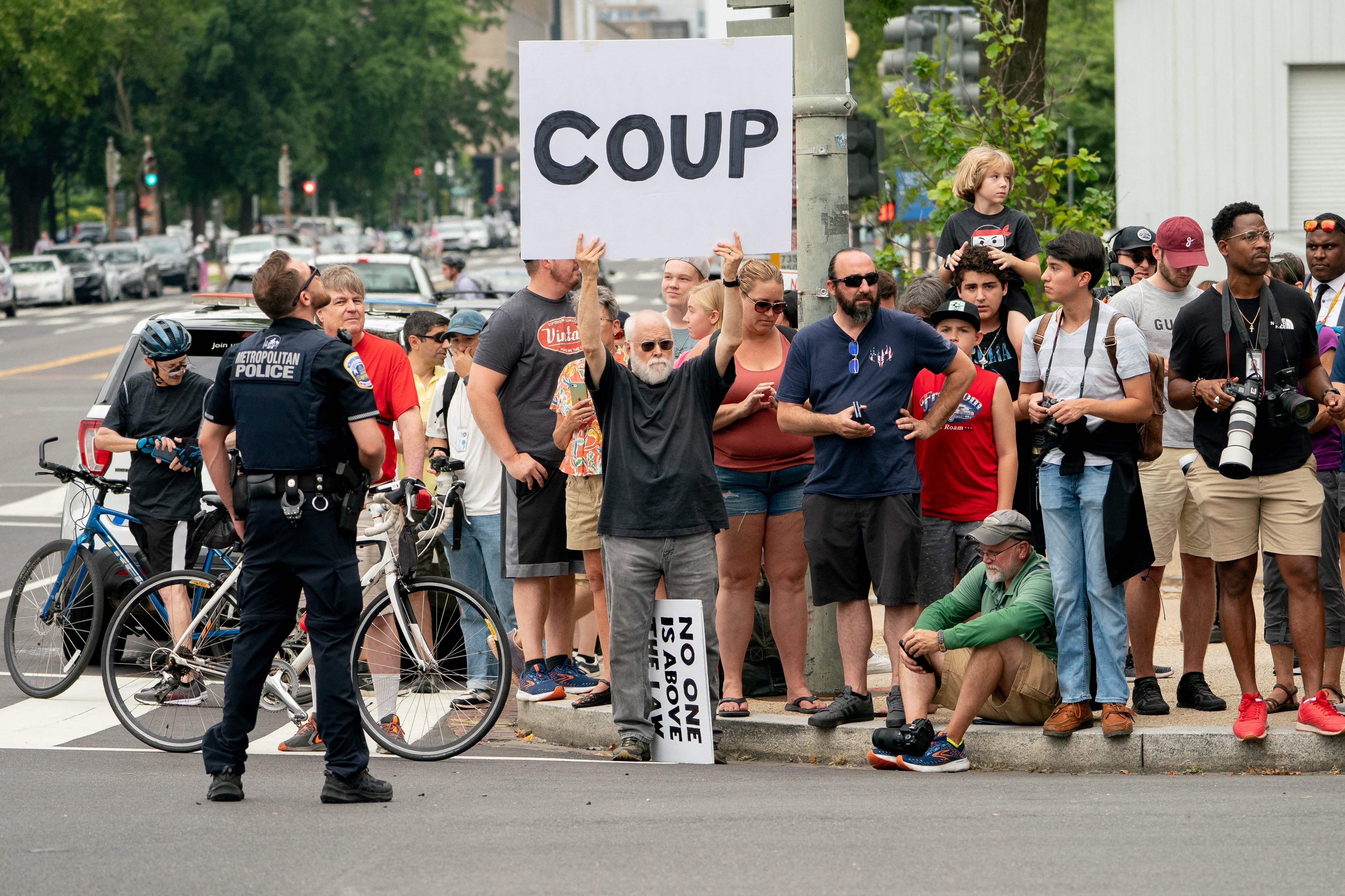 Demonstrators stand outside the E. Barrett Prettyman US Courthouse in Washington, DC, on August 3, 2023, ahead of the arraignment of former US President Donald Trump.