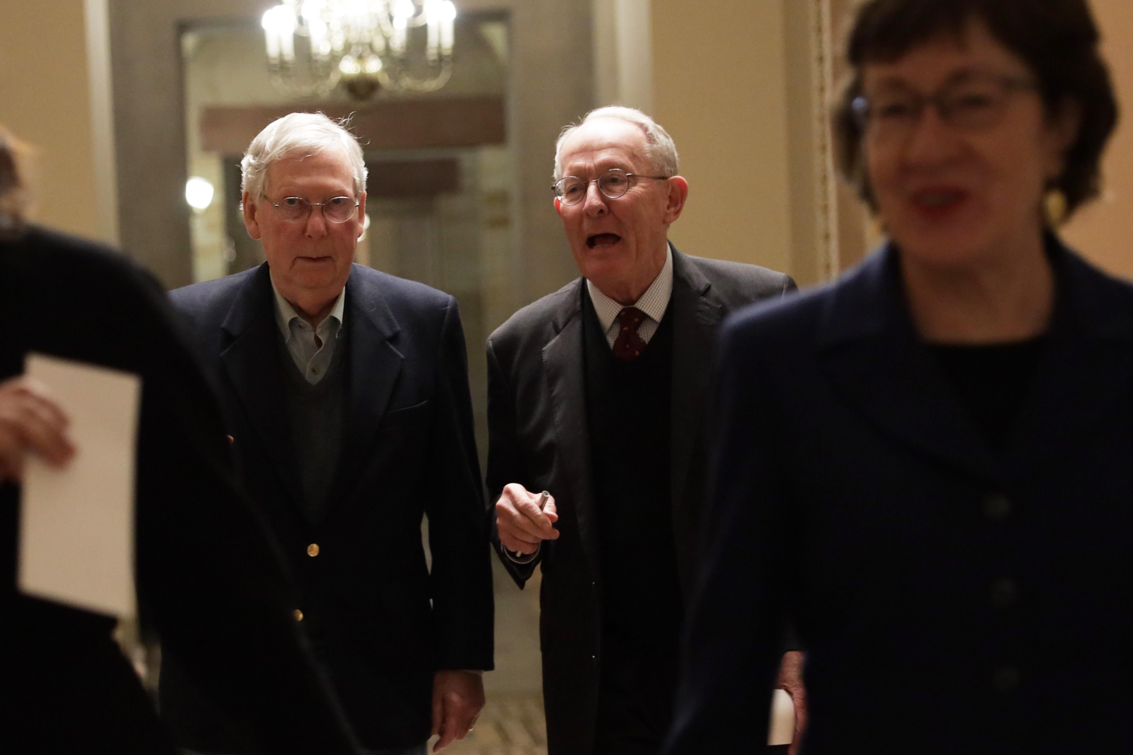 U.S. Senate Majority Leader Sen. Mitch McConnell walks with Sen. Lamar Alexander and Sen. Susan Collins in a hallway after a vote December 2, 2019 at the U.S. Capitol in Washington, DC. 