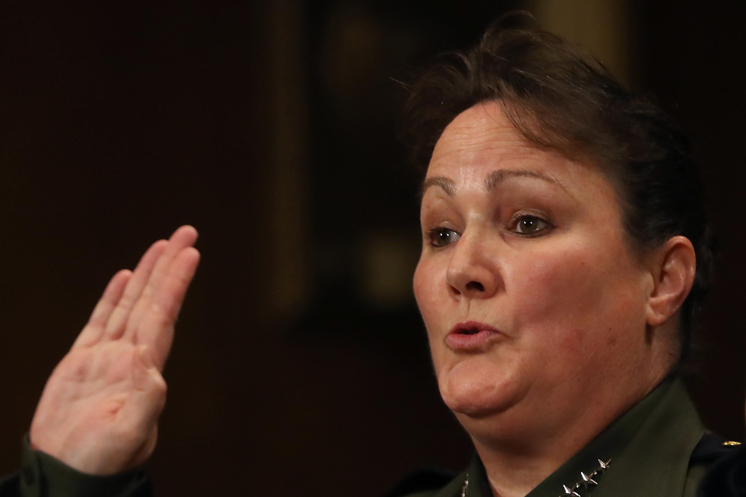 Carla Provost raises her hand to be sworn in.