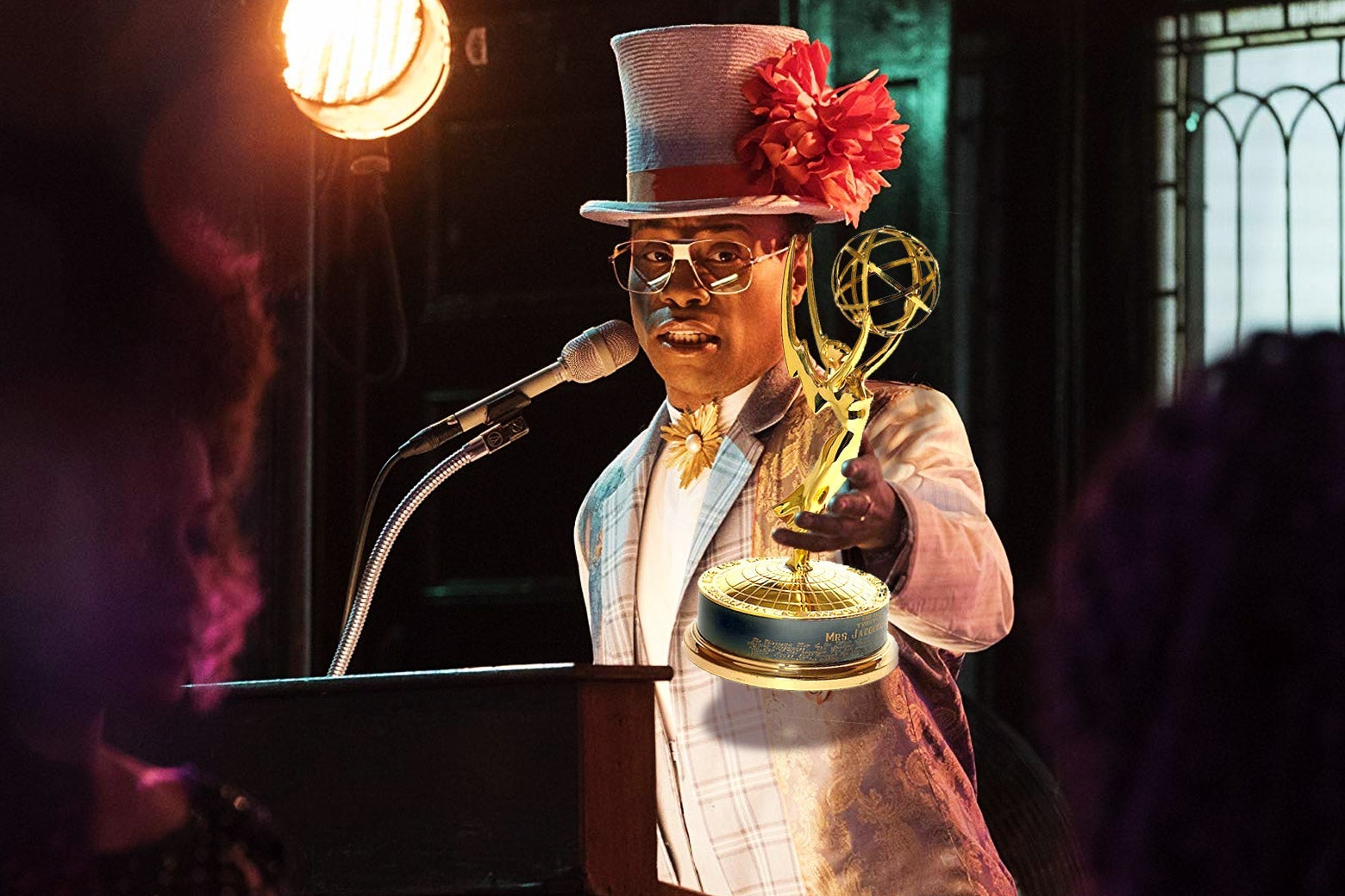 Billy Porter in Pose holding an Emmy.