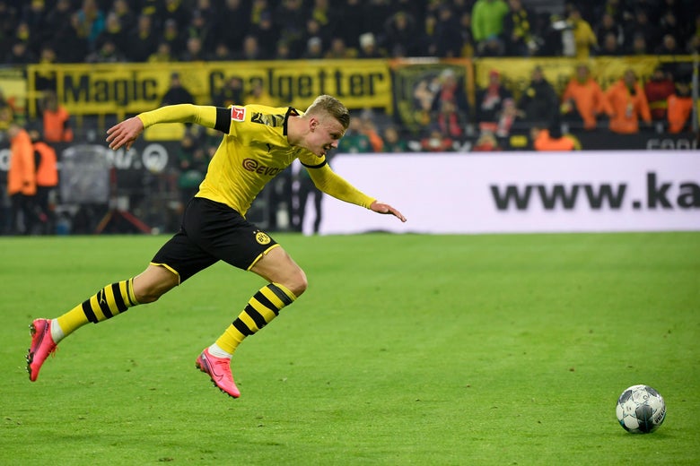 Dortmund's Norwegian forward Erling Braut Haaland lunges forward toward a soccer ball