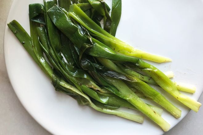 Cooked scallions on a plate.