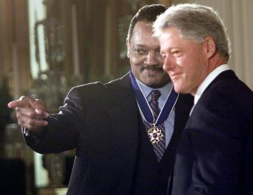 President Bill Clinton (R) presents the Rev. Jesse Jackson (L) with the Presidential Medal of Freedom in the East Room of the White House, August 2000 in Washington, DC.