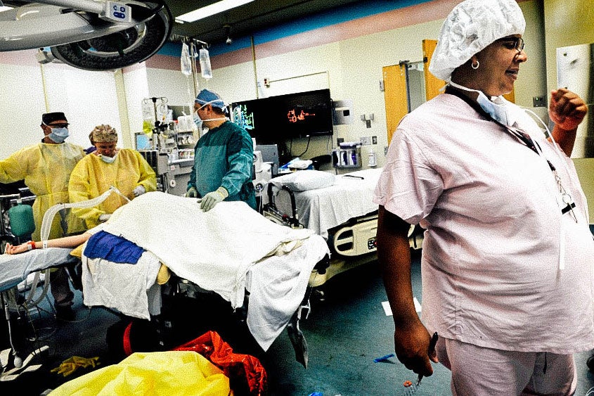 Laurie in scrubs in an operating room.