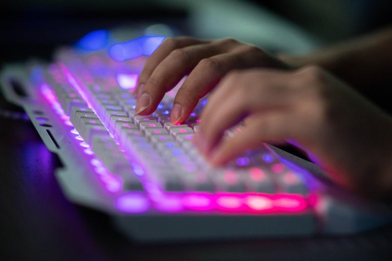 An unnamed hacker, typing on a computer keyboard.