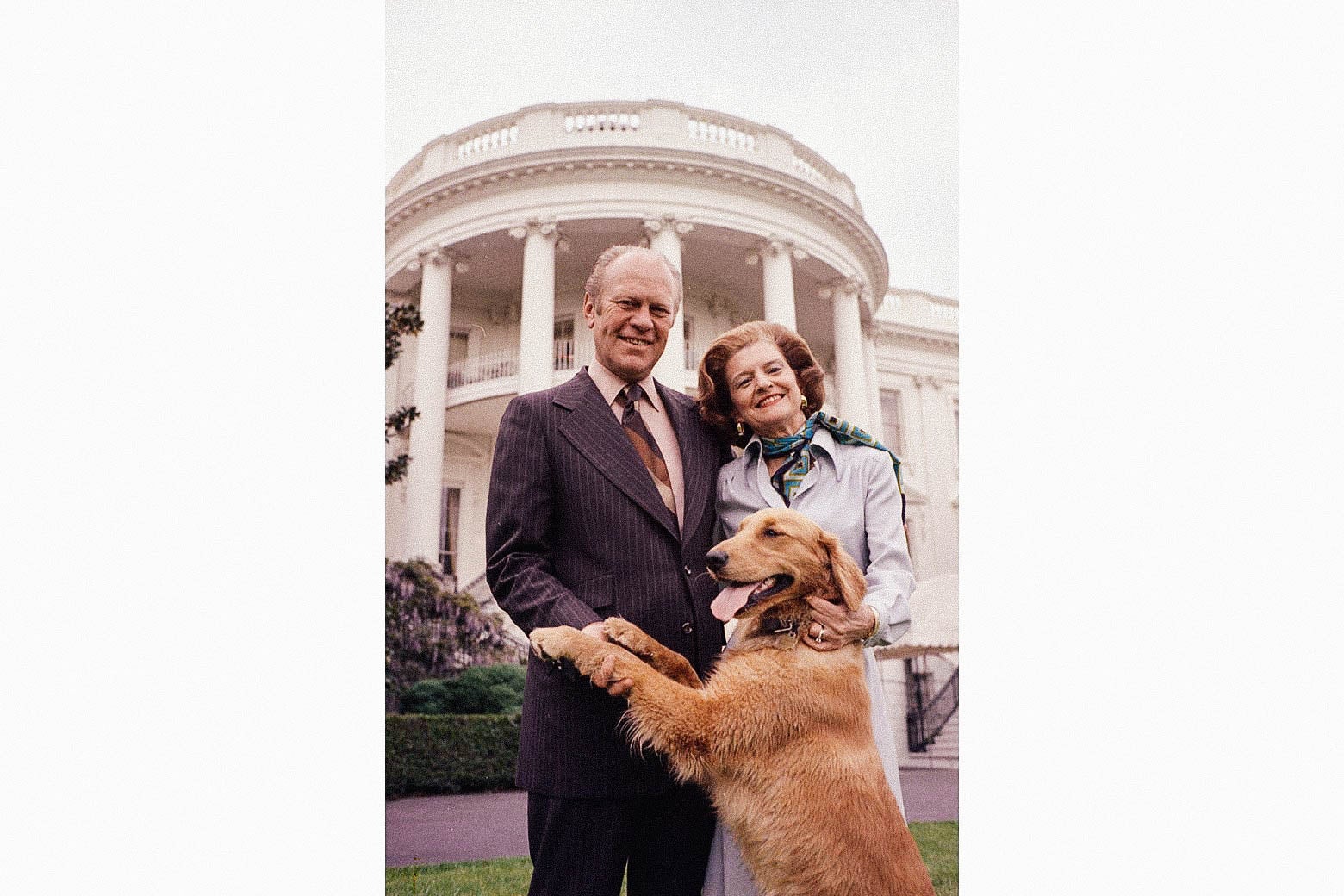 Gerald and Betty Ford stand on the White House lawn with their golden retriever.
