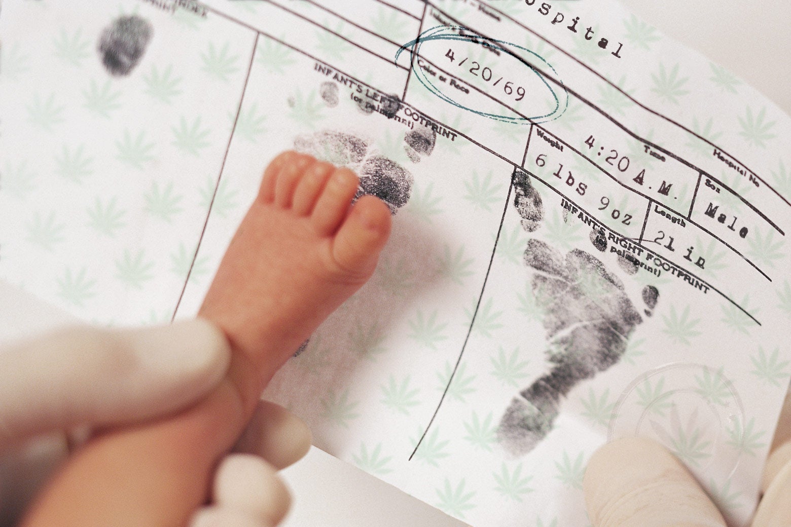 A baby's foot being stamped on a birth certificate dated 4/20/69.