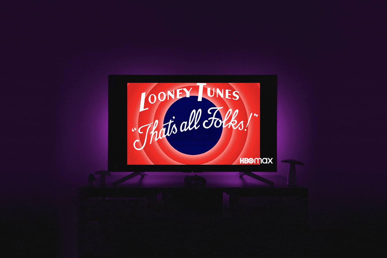  In a dark purple room, a TV screen with an HBO Max logo in the bottom right-hand corner plays "That's All Folks!" Looney Tunes outro.