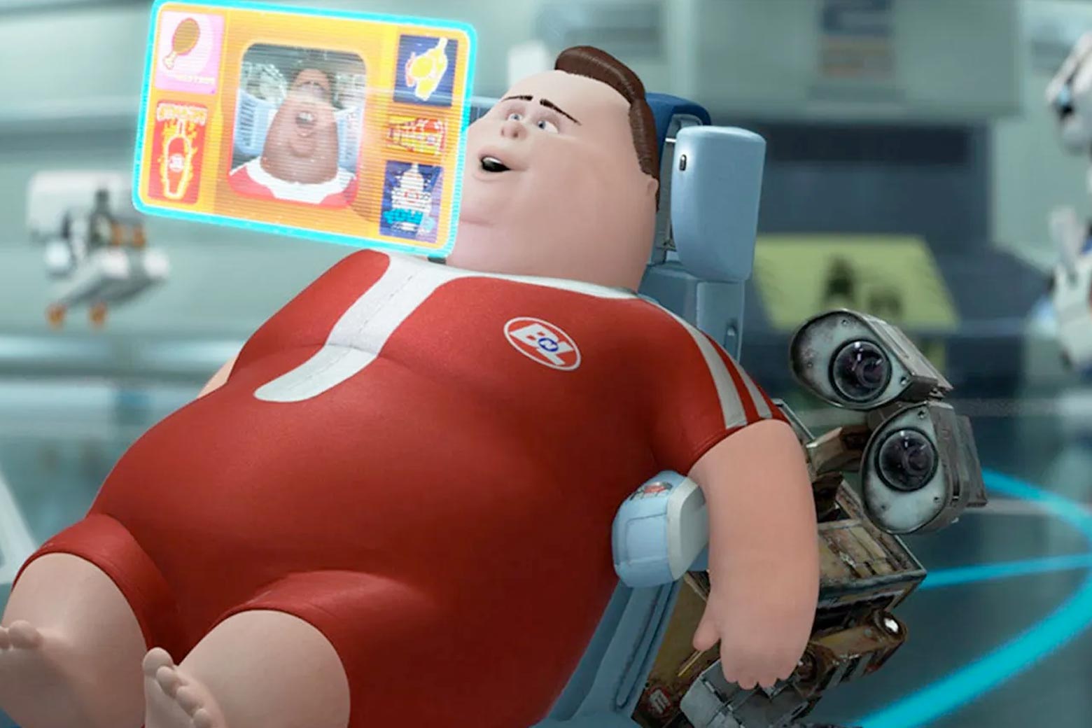 An overweight human character sits in a chair looking at a hovering screen in front of his face while WALL-E sneaks around behind him.