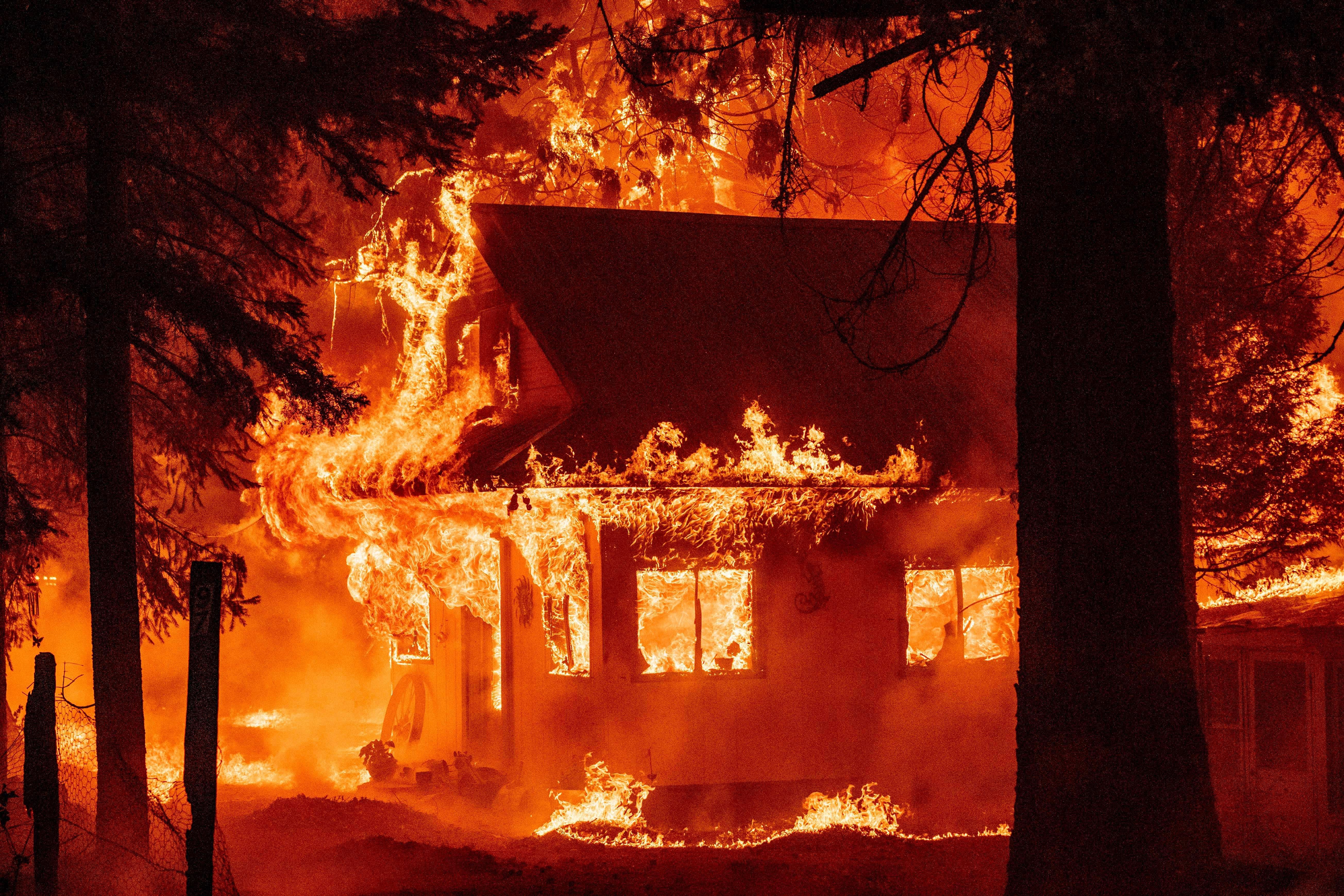 A home burns as the Dixie fire rips through the Indian Falls neighborhood of unincorporated Plumas County, California on July 24, 2021. 